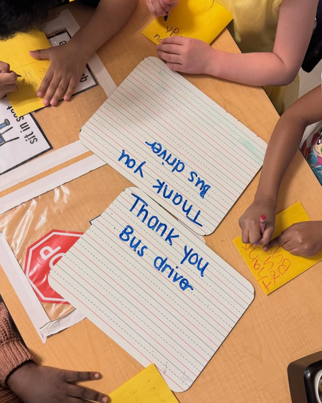 Students writing thanks to bus drivers